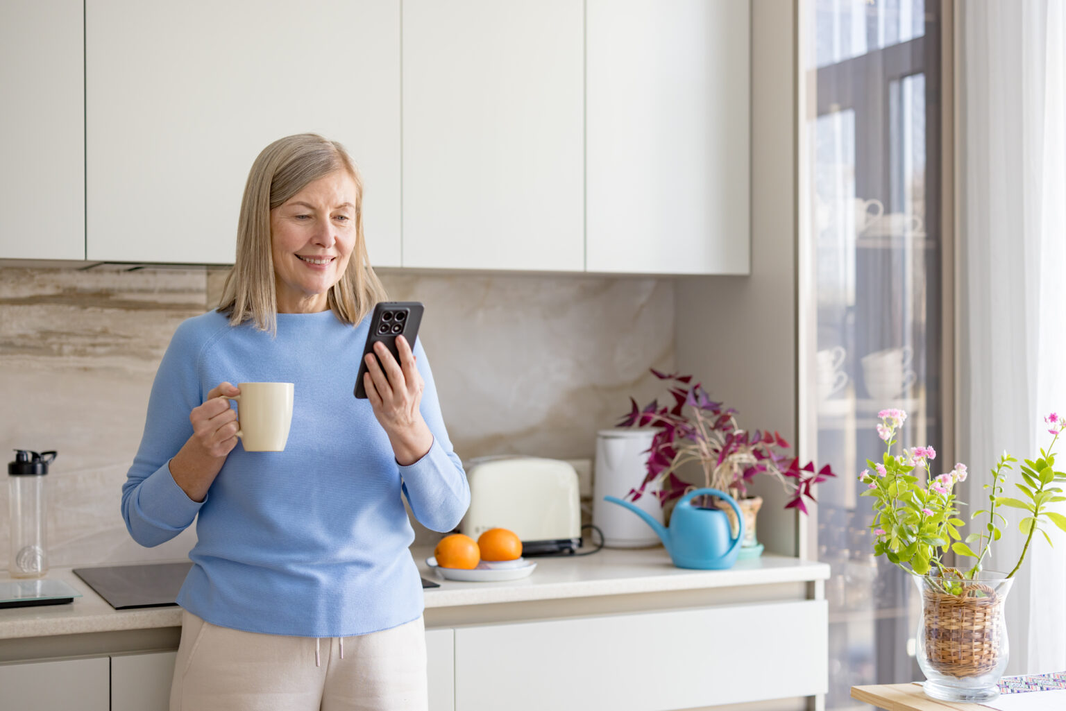 Woman checking her phone over coffee at home