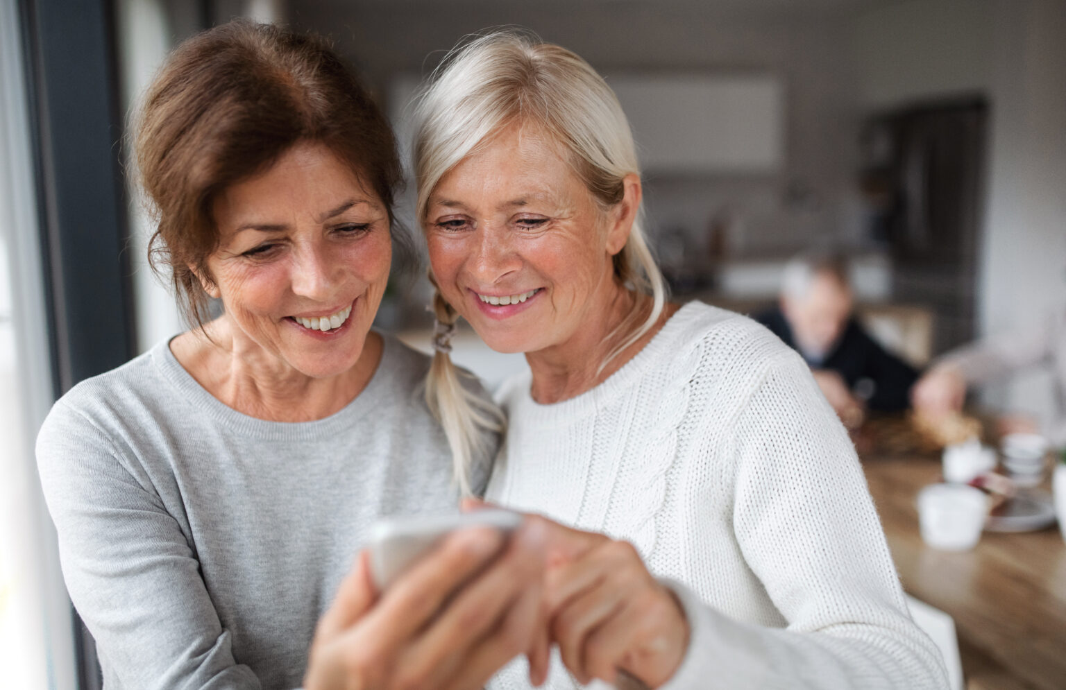 Two women looking at a smartphone together